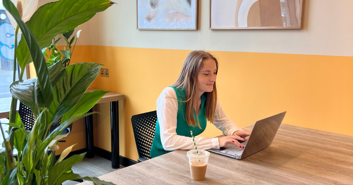 female student in room on laptop