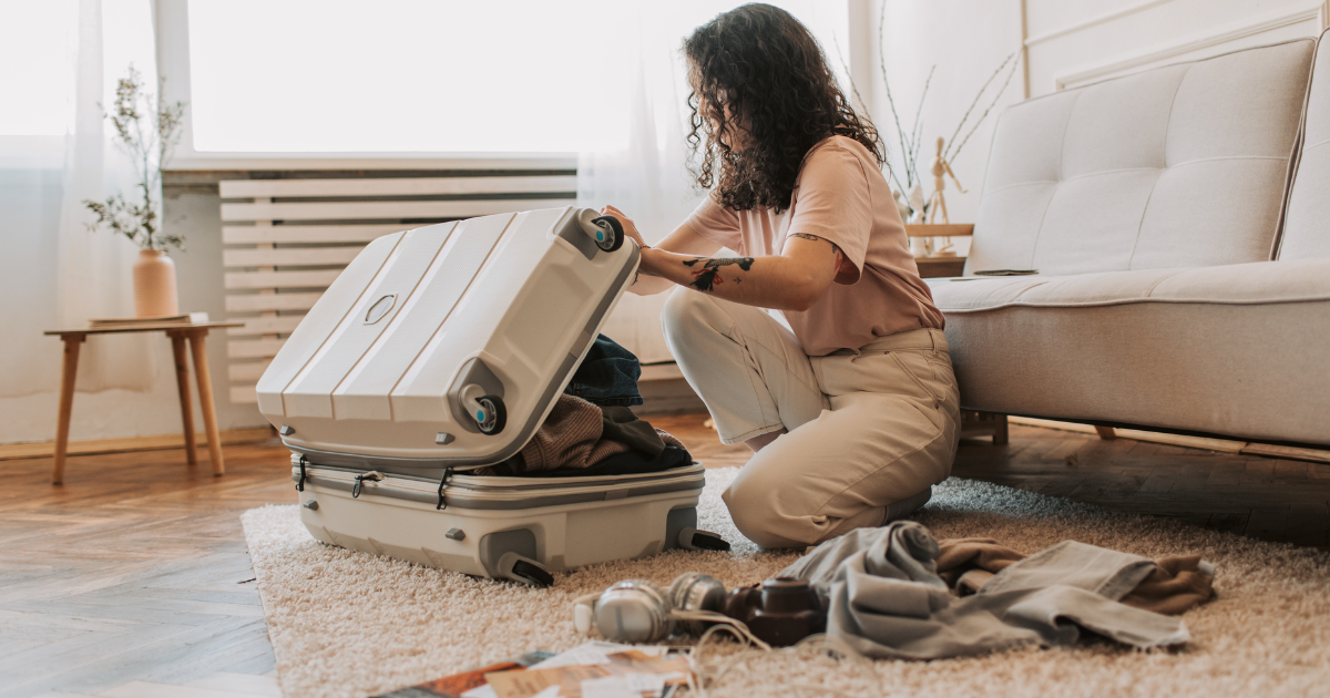 girl packing up suitcase for move